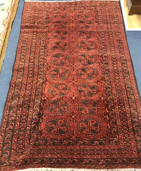 A Bokhara red ground rug 193 x 116cm